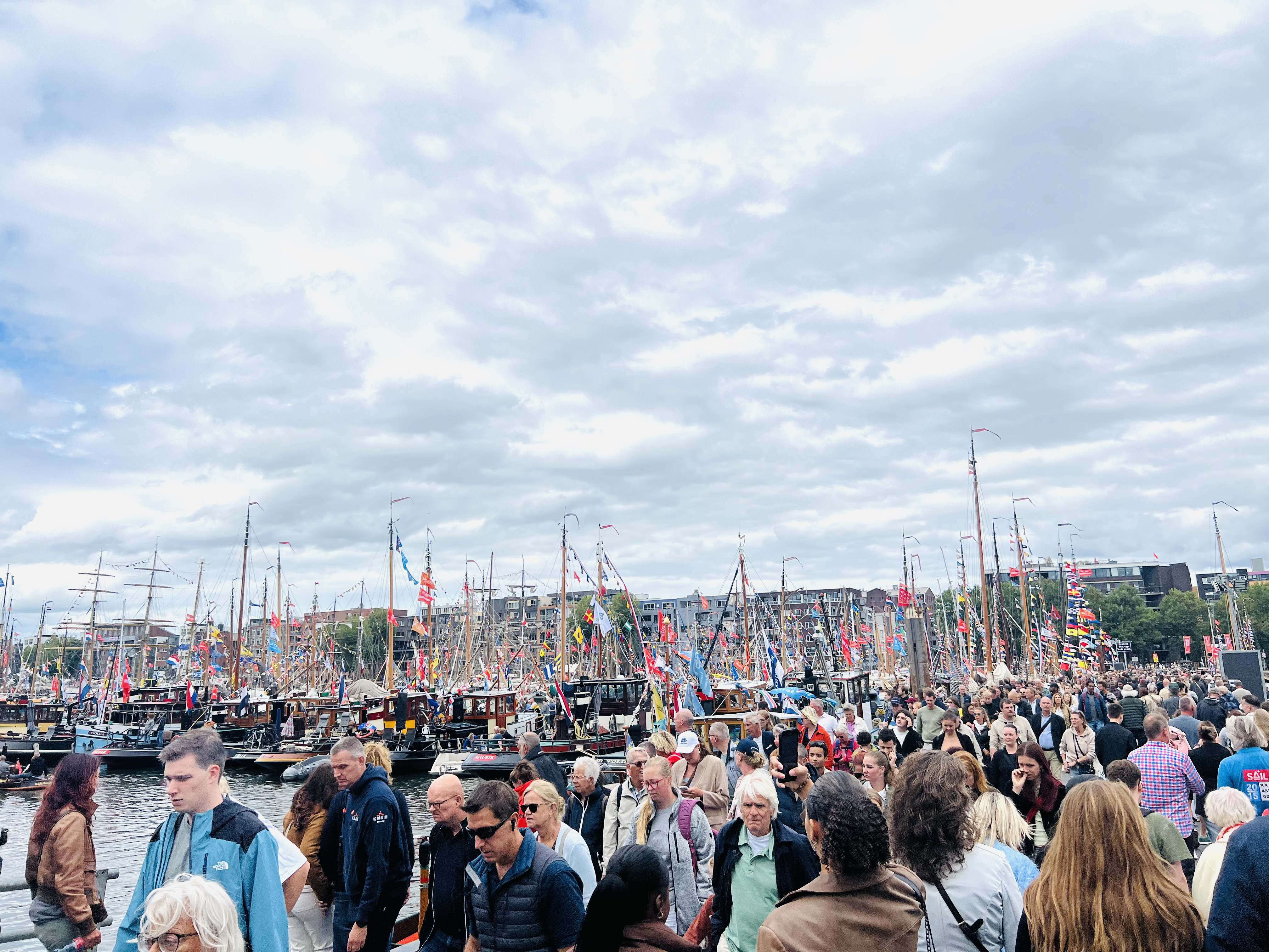 The smaller docked ships plus a huge crowd